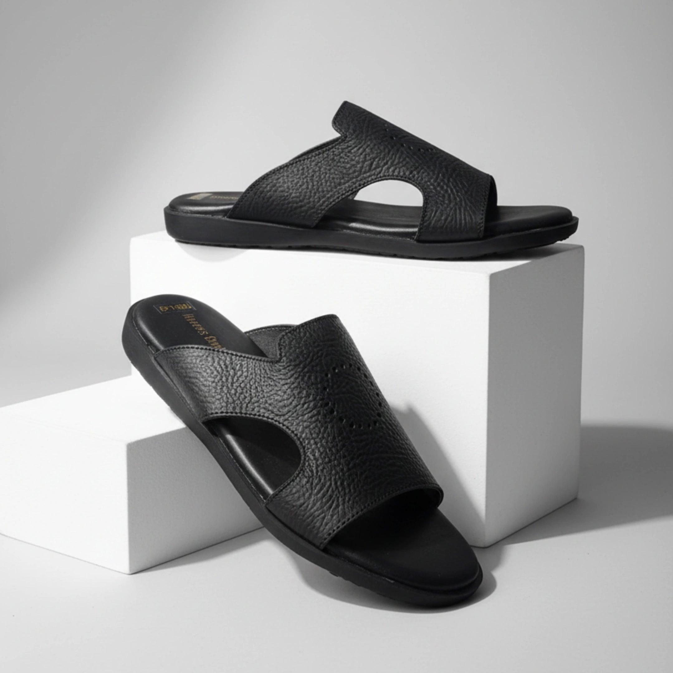 Black sandals on a white cube with a neutral background - BlackBole High Quality Sandal