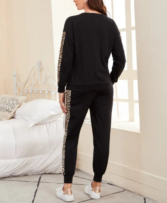 Person wearing a black tracksuit with leopard print side panels in a bedroom setting - BlackBole High Quality Western Dress