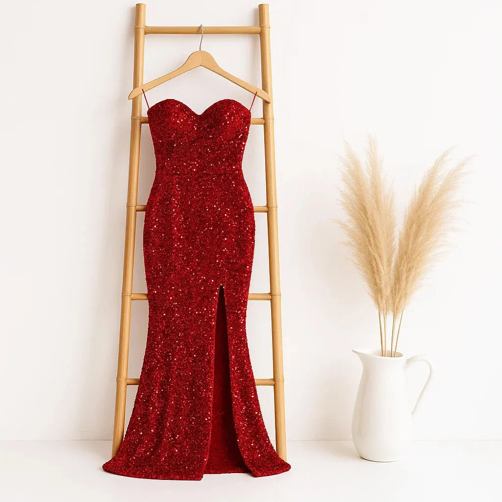 Red sequin dress on a hanger against a white wall with a decorative plant - BlackBole High Quality Western Dress