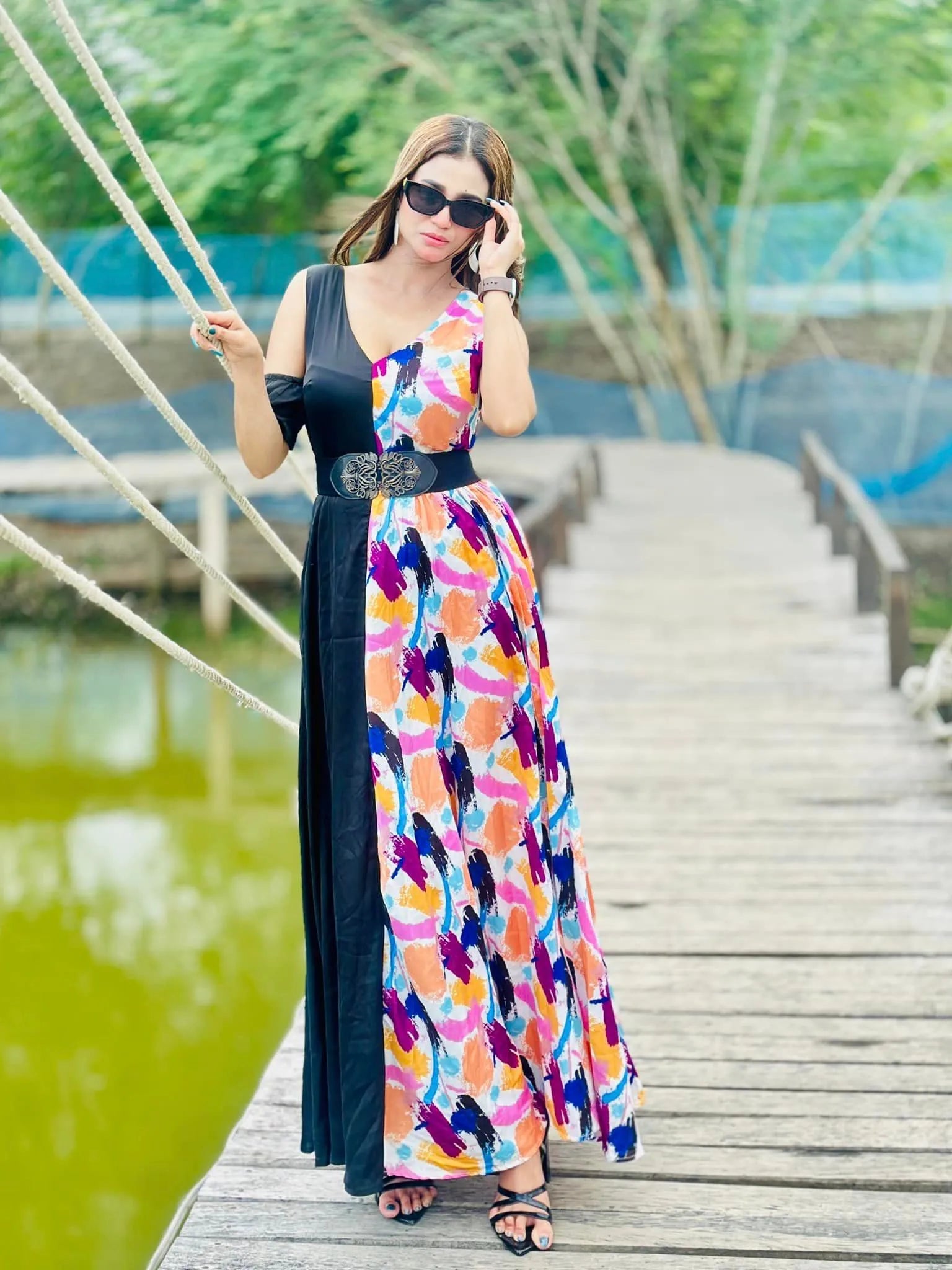 Woman in a colorful dress standing on a wooden bridge by a pond - BlackBole High Quality Western Dress