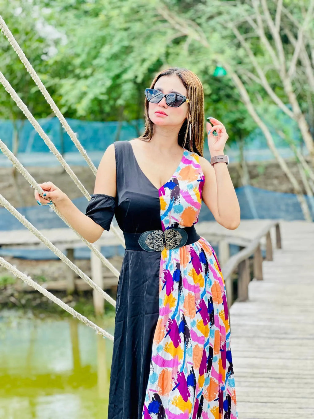 Woman wearing a black dress with a colorful floral pattern over it, standing outdoors near a body of water - BlackBole High Quality Western Dress