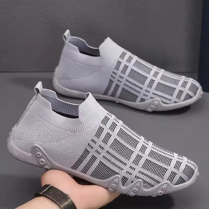 A pair of men's breathable and waterproof gym shoes in black color with a checkered pattern, displayed on a person's hand -- BlackBole High Quality Shoe