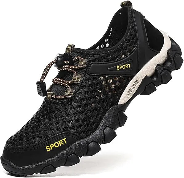 Black and yellow athletic shoe on a person's foot against a natural background - BlackBole High Quality Shoe