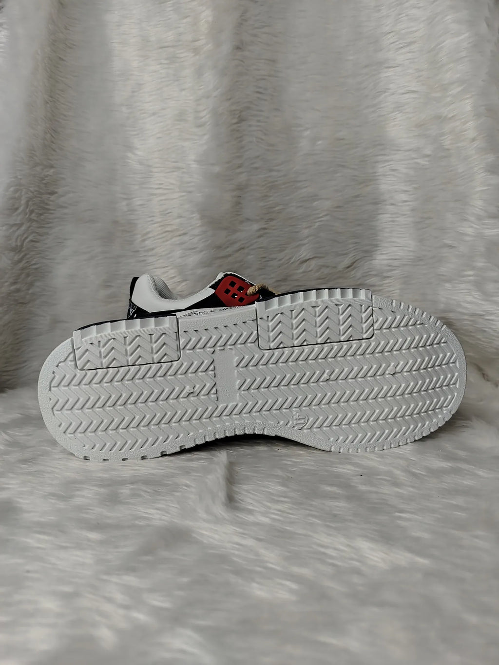 White sneaker with red character on a gray textured background - BlackBole High Quality Shoe