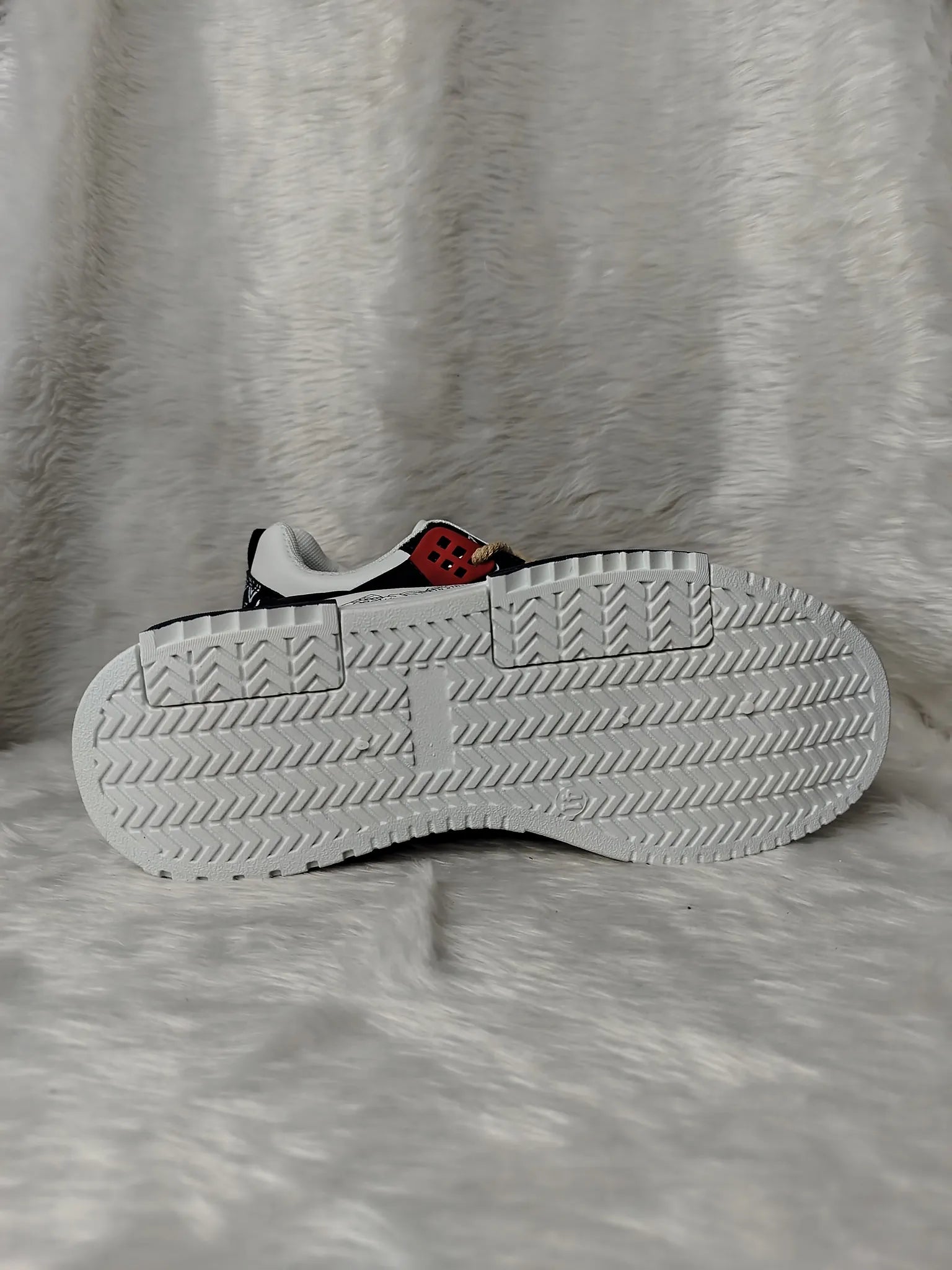 White sneaker with red character on a gray textured background - BlackBole High Quality Shoe