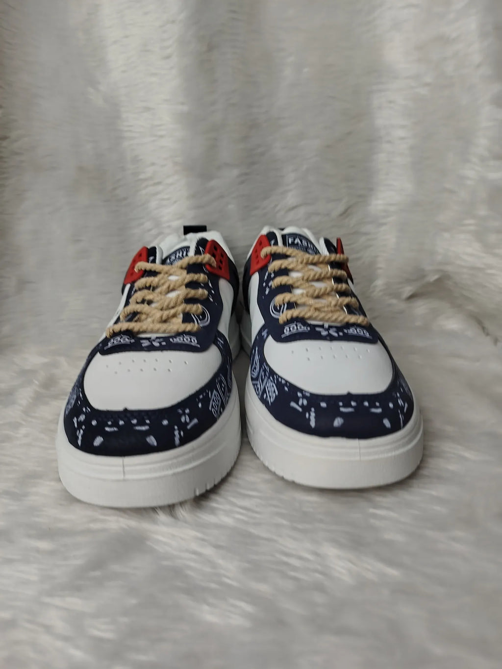 Pair of sneakers with a patterned sole on a textured surface - BlackBole High Quality Shoe