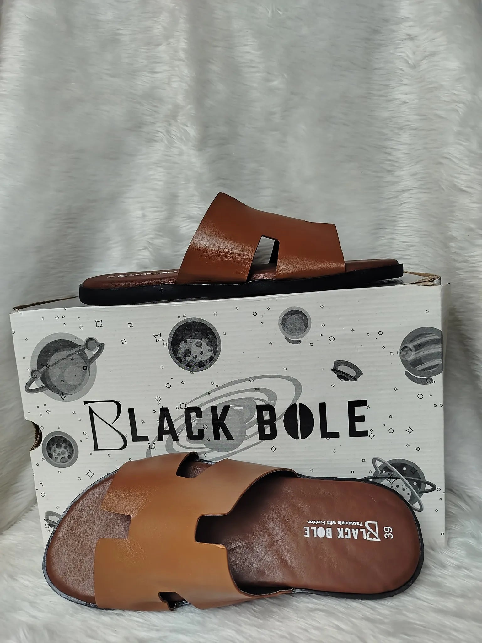 Brown sandals on a 'Black Bole' branded box against a gray background - BlackBole High Quality Sandal