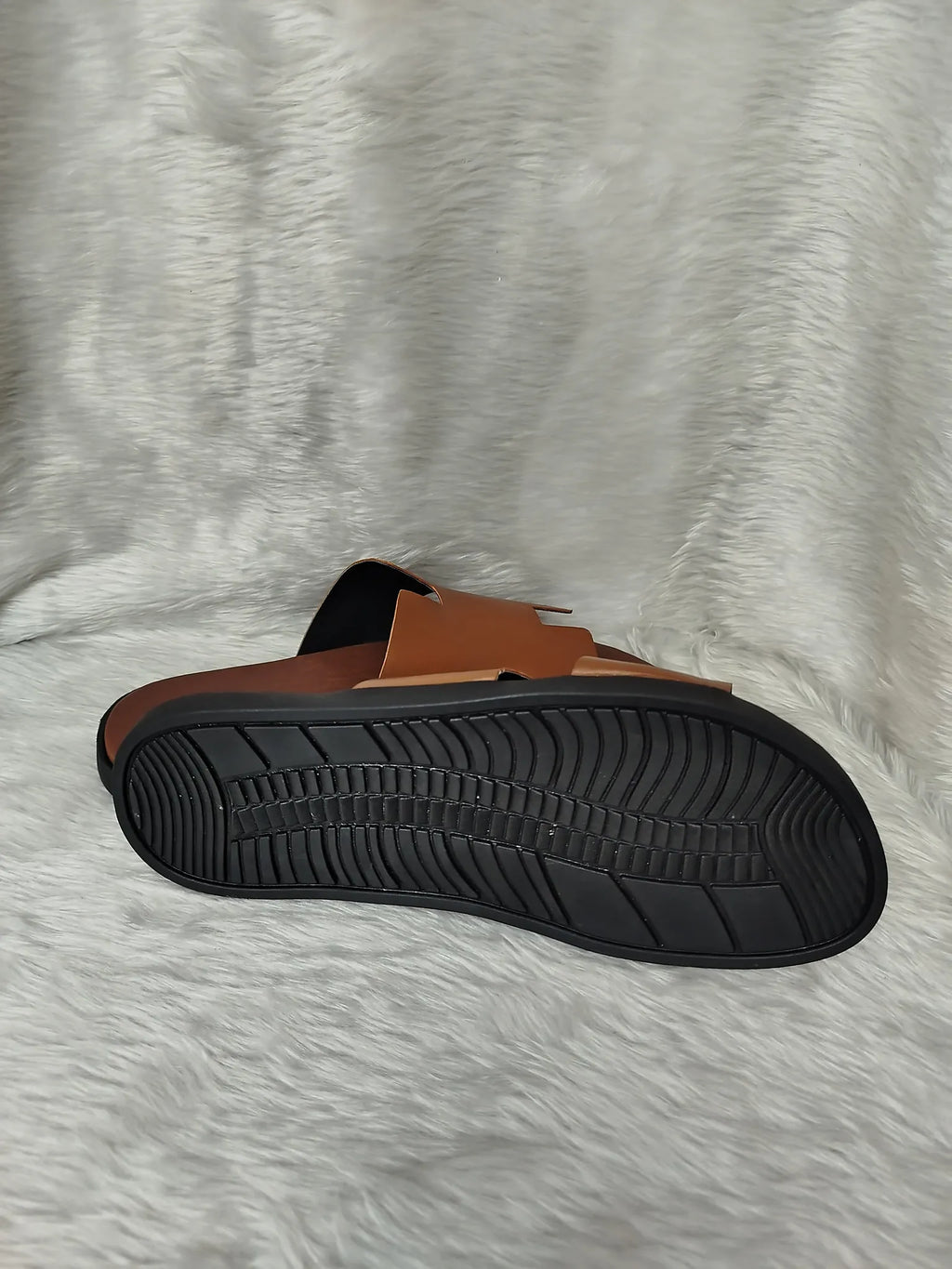 Brown sandal with black sole on a textured white background - BlackBole High Quality Sandal