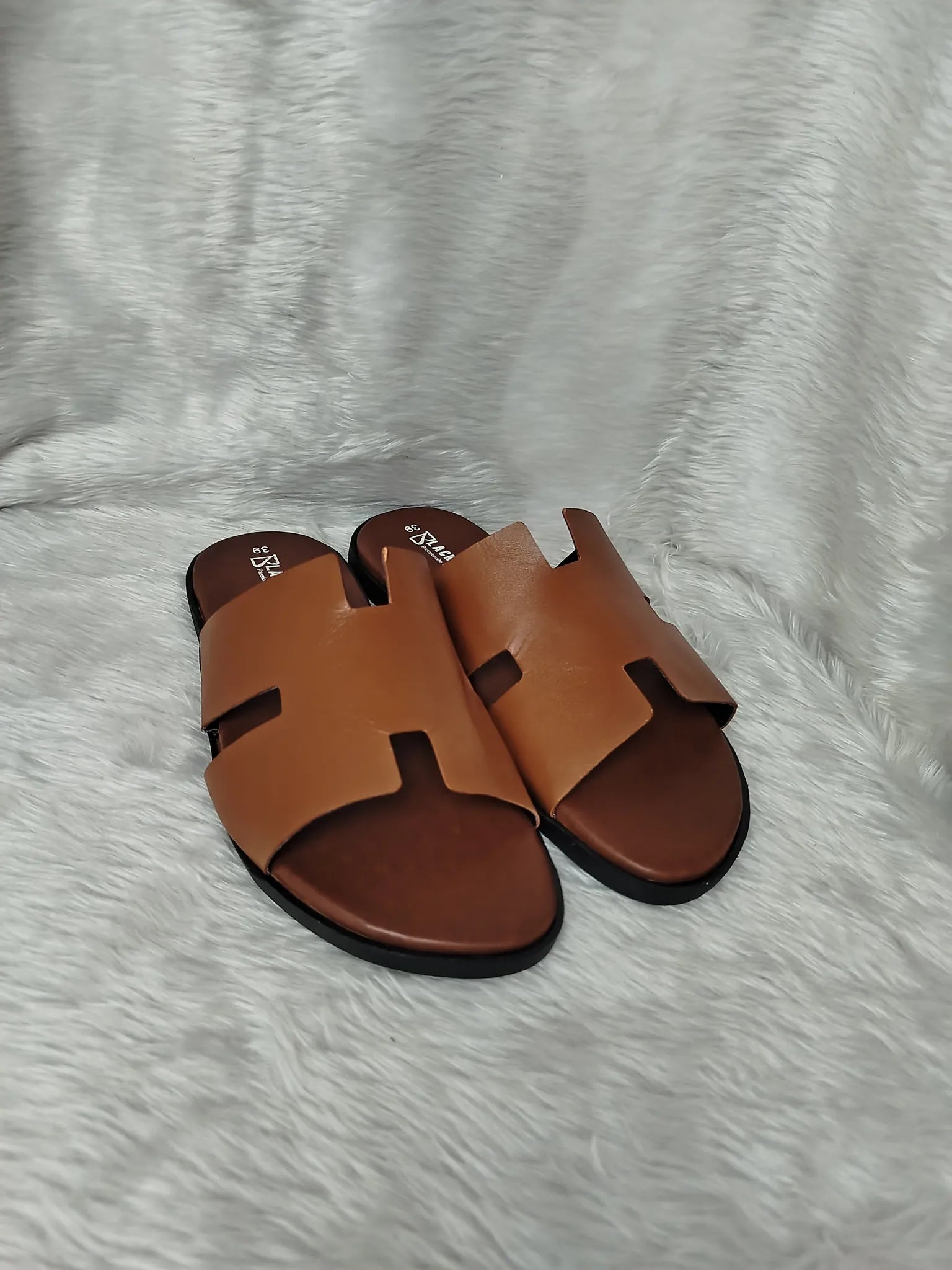 Pair of brown sandals on a textured white surface - BlackBole High Quality Sandal