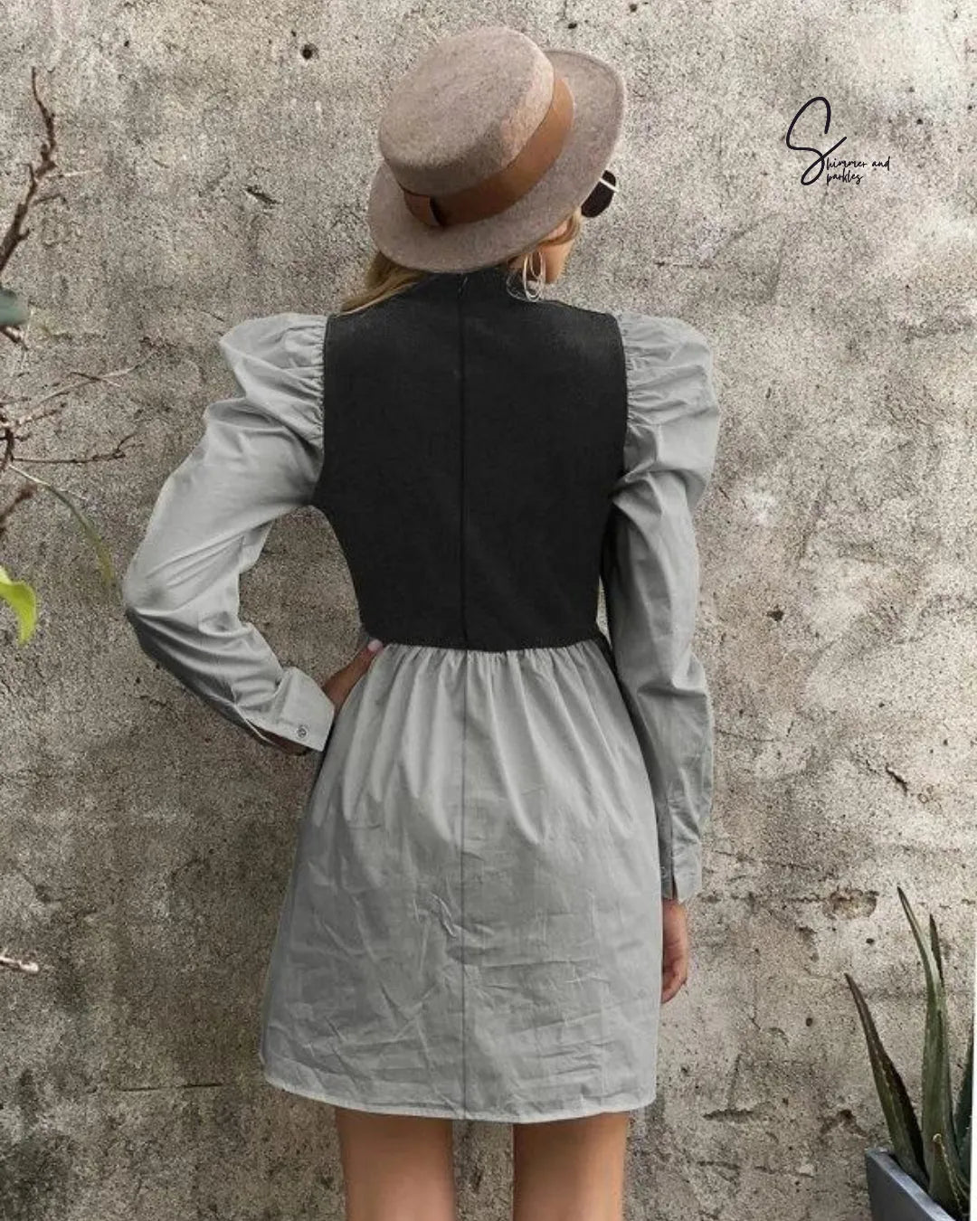 Person wearing a black vest over a light gray dress with a wide-brimmed hat against a textured wall - BlackBole High Quality Western Dress