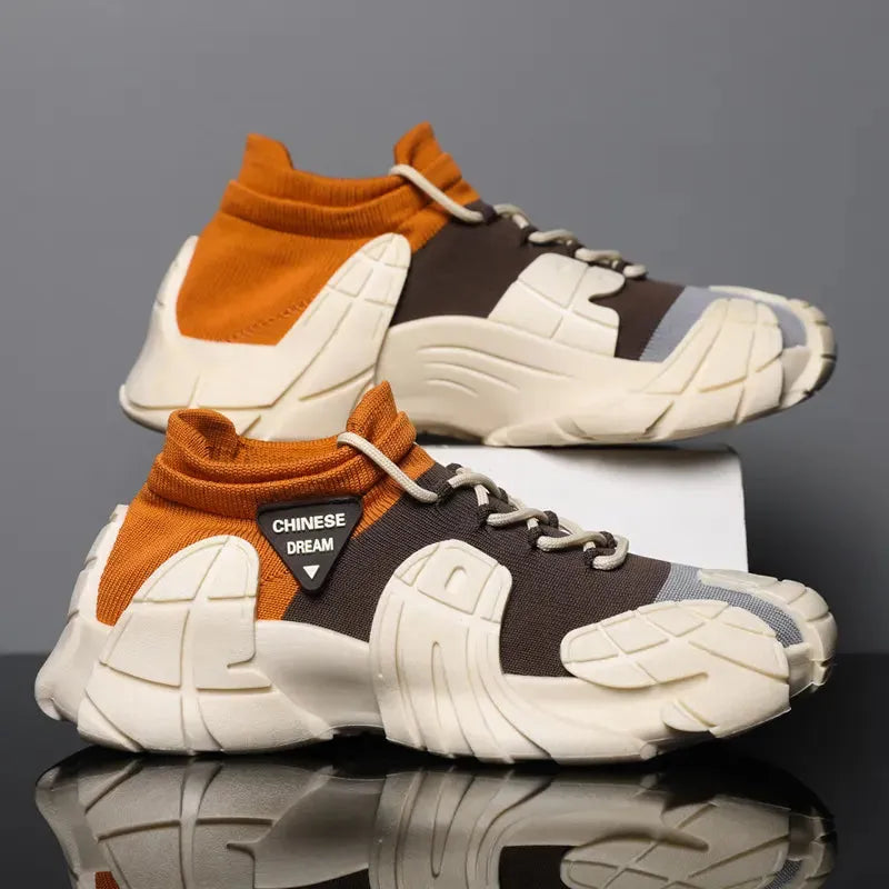 Pair of brown and white sneakers with orange accents on a reflective surface - BlackBole High Quality Shoe