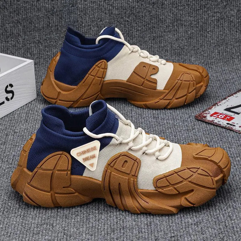 A pair of high-performance sneakers with beige, blue, and brown colors. The shoes have a rugged texture and are displayed alongside a white box with a logo and a brown surface - BlackBole High Quality Shoe