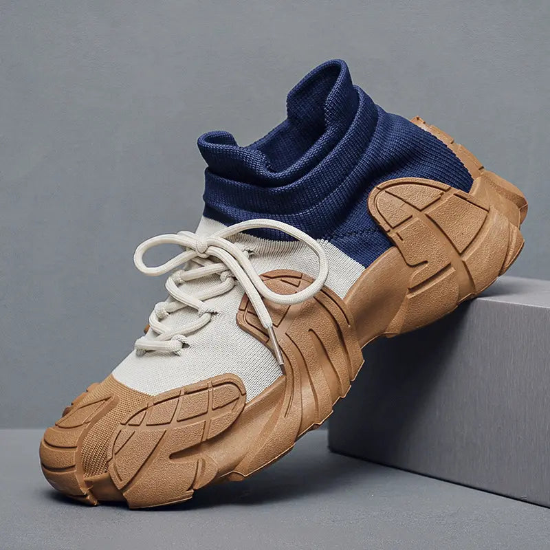 A pair of high-performance sneakers with beige, blue, and brown colors. The shoes have a rugged texture and are displayed alongside a white box with a logo and a brown surface - BlackBole High Quality Shoe
