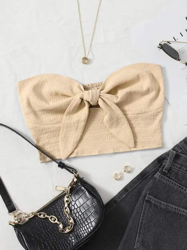 Beige bow top with black handbag, earrings, and jeans on a white surface - BlackBole High Quality Western Dress