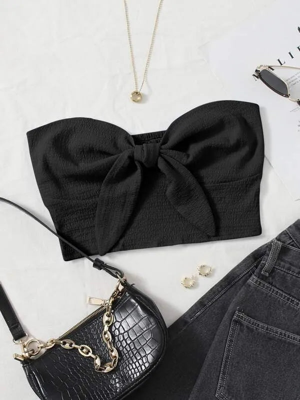 Black strapless top with a large bow, black handbag, necklace, and earrings on a white surface - BlackBole High Quality Western Dress