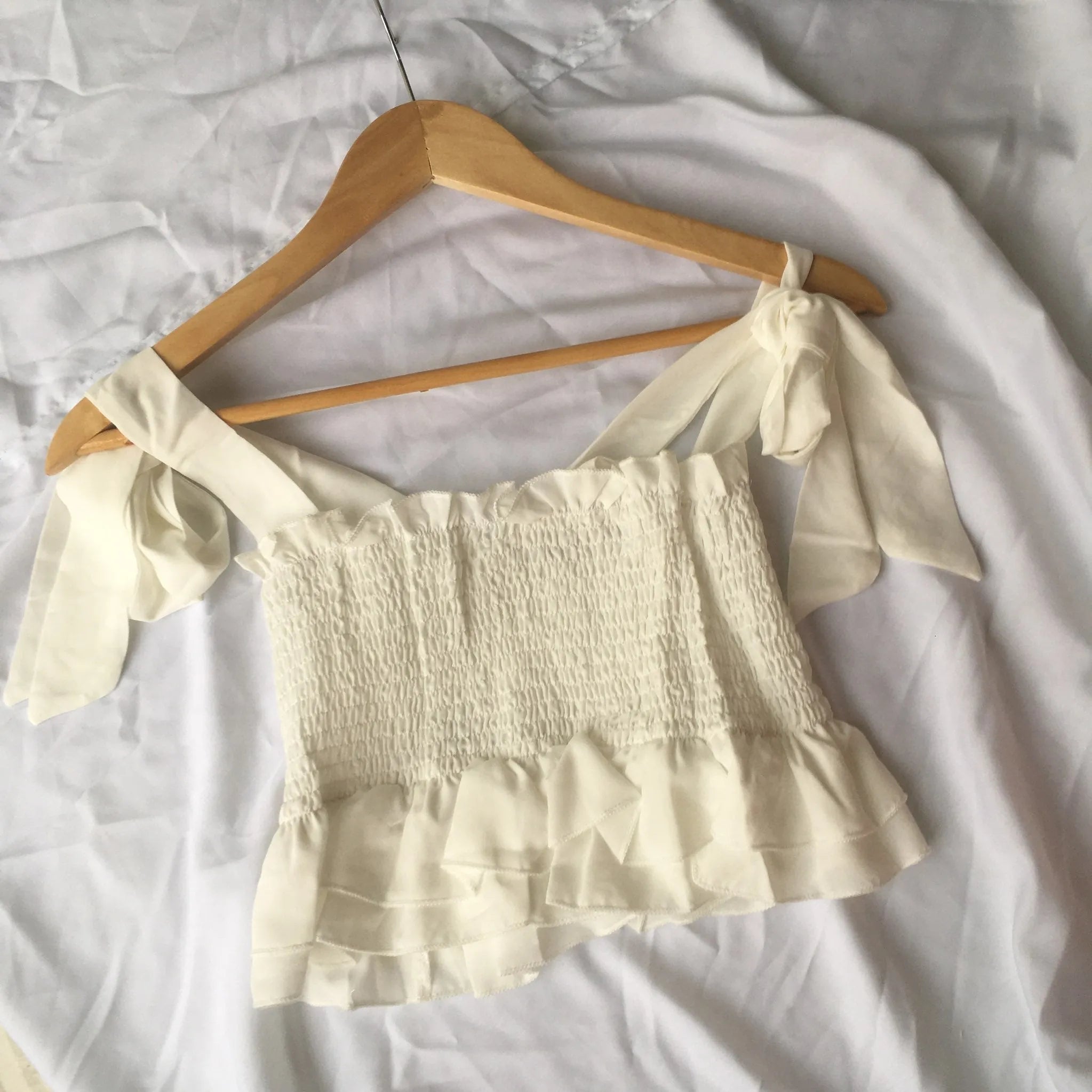 Beige off-shoulder top on a wooden hanger against a white background - BlackBole High Quality western Dress