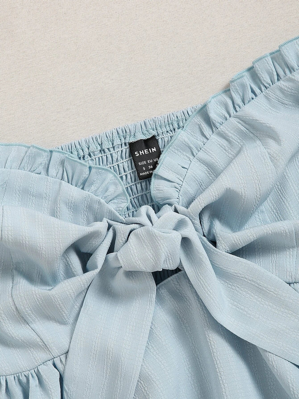 Light blue fabric with a visible 'SHEIN' label on a beige background - BlackBole High Quality Western Dress