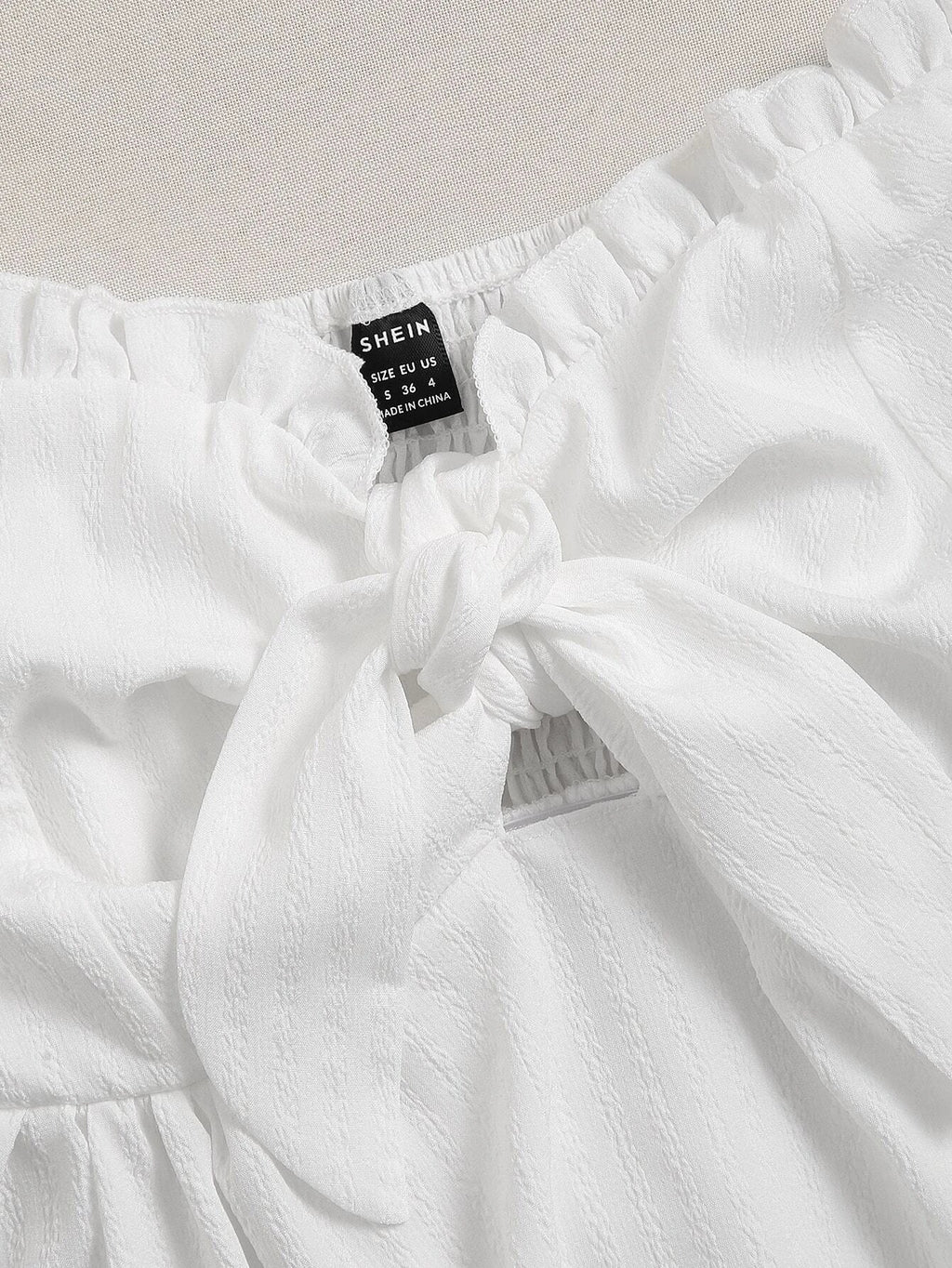 White fabric with a visible 'SHEIN' label on a light gray background - BlackBole High Quality Western Dress