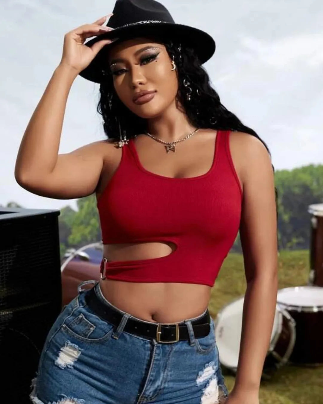 Woman wearing a red crop top and denim shorts with a black hat outdoors - BlackBole High Quality Western Dress
