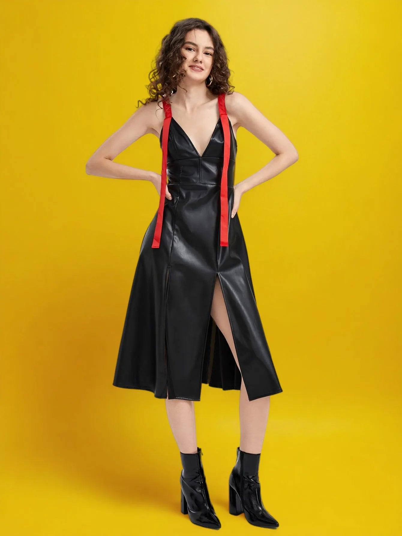 Woman wearing a black leather dress with red straps on a yellow background - BlackBole High Quality Western Dress