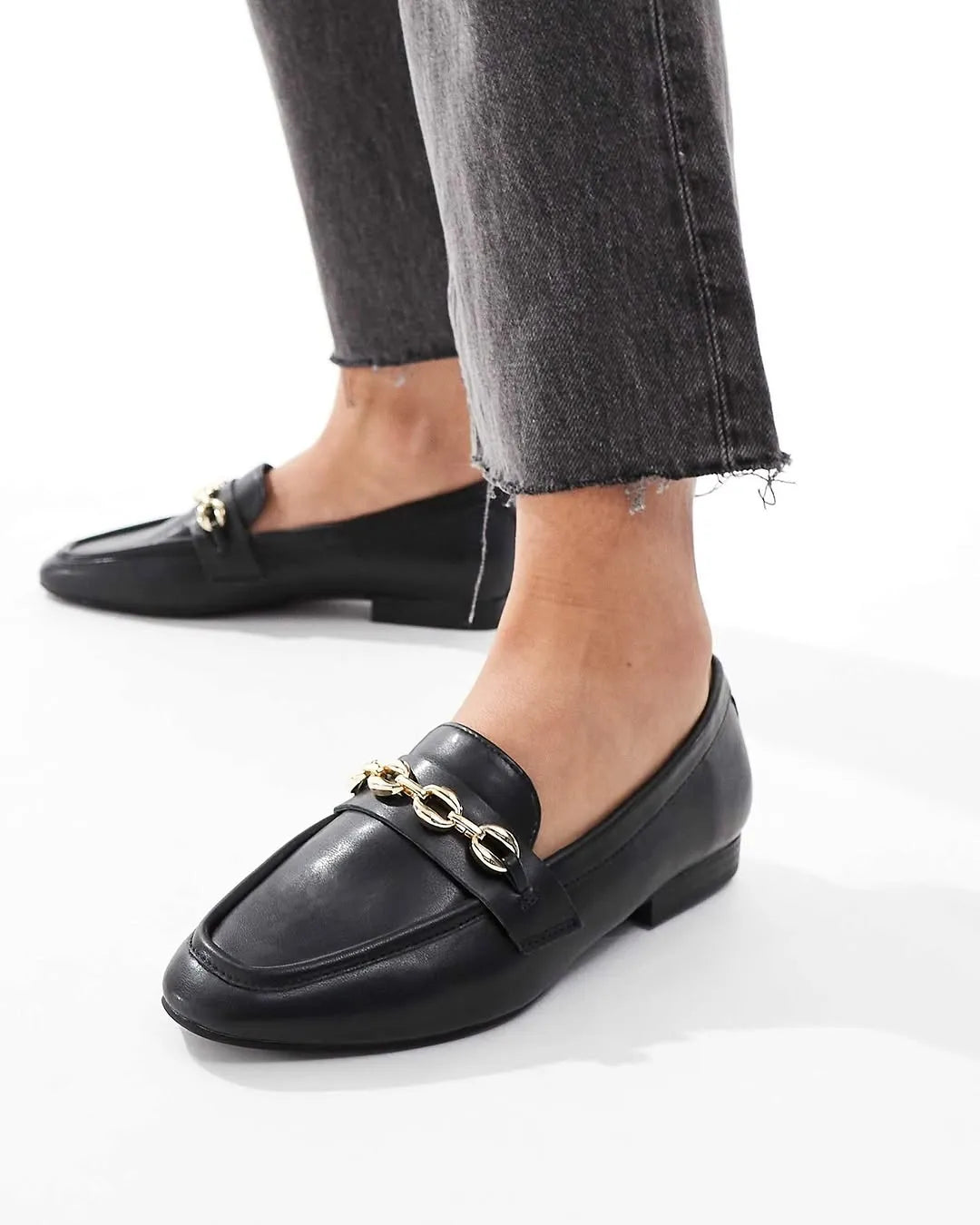 Black loafers with gold chain detail worn with gray jeans on a white  background - BlackBole High Quality Shoe