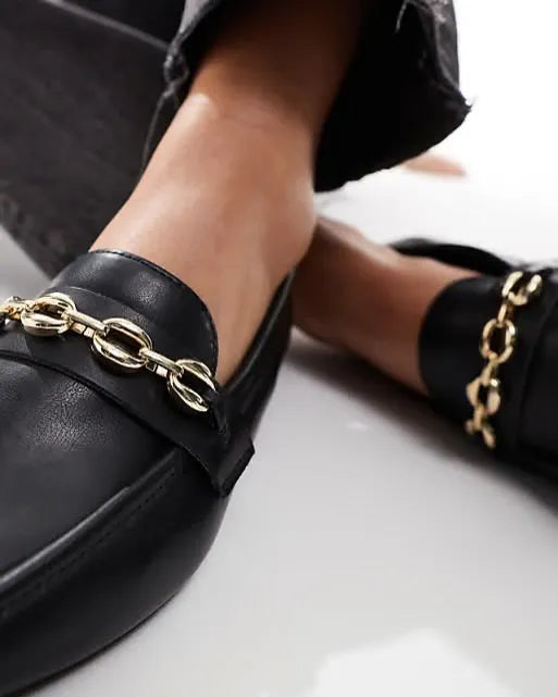Black loafers with gold chain details worn by a person on a light background - BlackBole High Quality Shoe