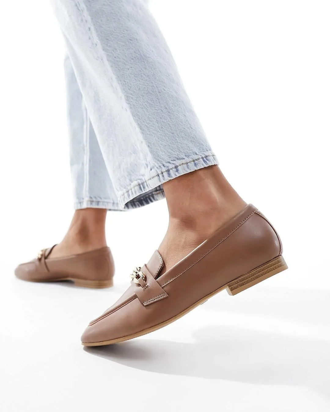 Brown loafers worn with light blue jeans on a white background - BlackBole High Quality Shoe