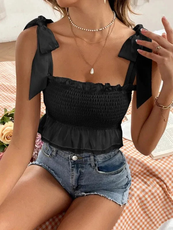 Woman wearing a black top with bow straps and denim shorts on a checkered blanket - BlackBole High Quality Western Dress