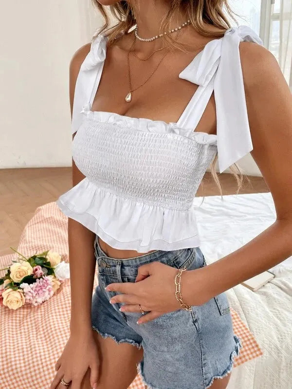 Woman wearing a white smocked top and denim shorts with a blurred background - BlackBole High Quality Western Dress